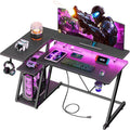 Korfile 40 Inch Gaming Desk with Power Outlet & LED Lights, L Shaped Computer Gaming Table with 3 Tiers Storage Shelves, Corner Gamer Desk with Monitor Stand for Small Space, Carbon Fiber Black