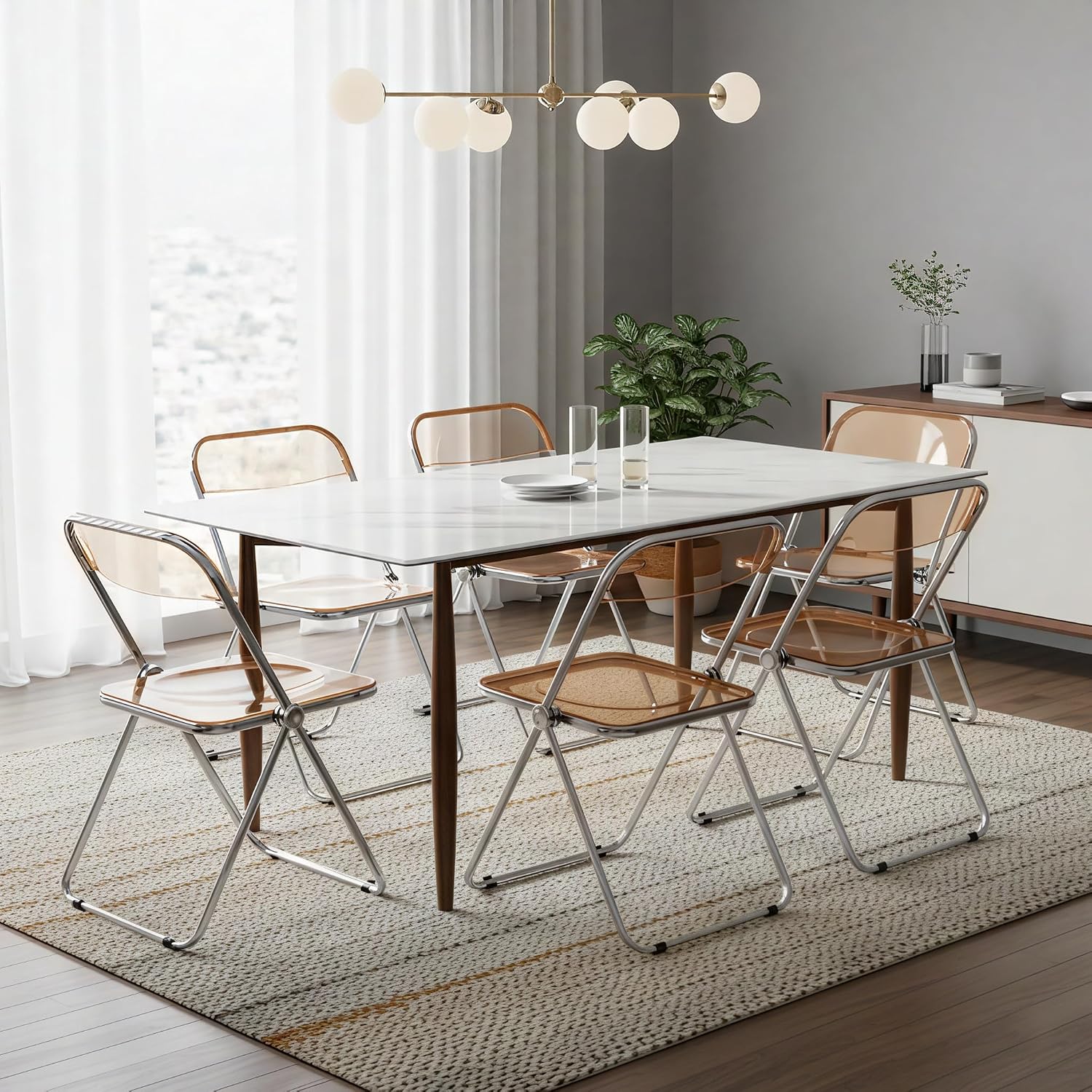LeisureMod Lawrence Modern Clear Acrylic Folding Chair with Metal Frame, Space-Saving Transparent Seating for Dining Room, Home Office, Bedroom, Vanity or Small Spaces, (Amber, Set of 4)