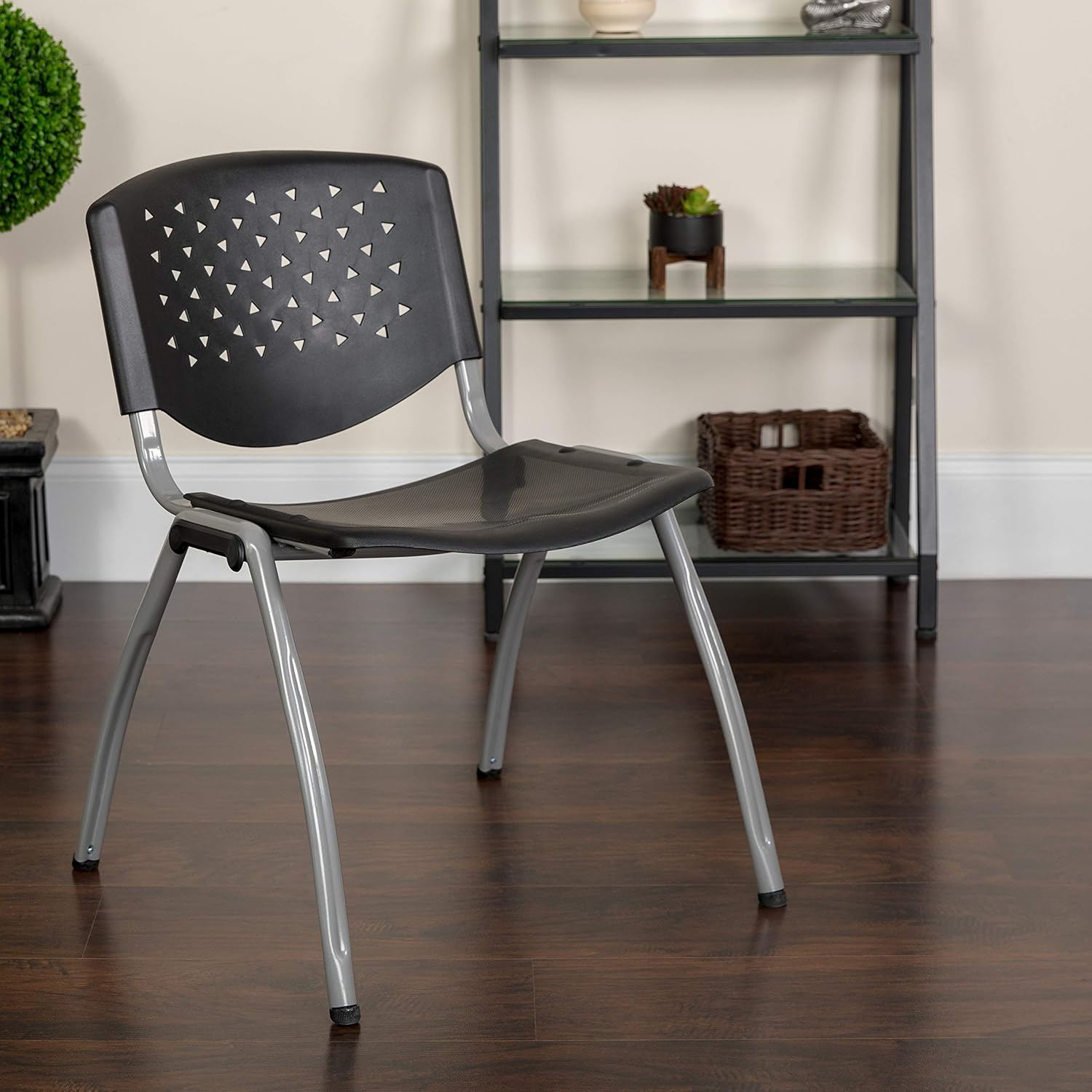 EMMA + OLIVER Home and Office Black Plastic Stack Chair with Perforated Back - Guest Chair